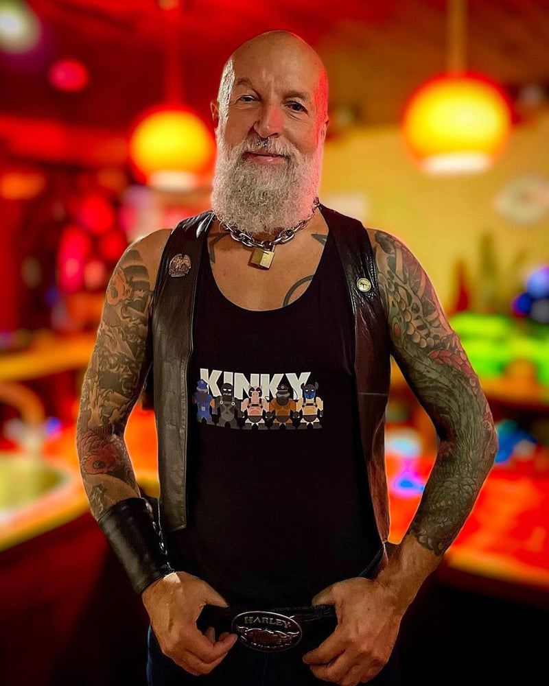 A tattooed man in a leather vest over the Kinky Mates tank