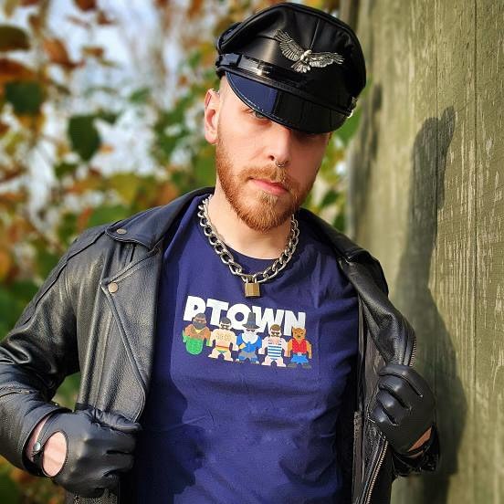 A man in a leather cap and jacket over a navy Provincetown Mates top