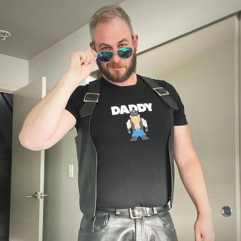 A man in a leather harness over the black Daddy Don tee