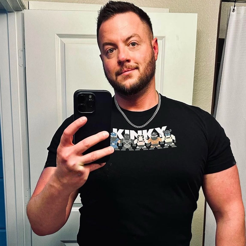 A man taking a mirror selfie in the Kinky Mates tee