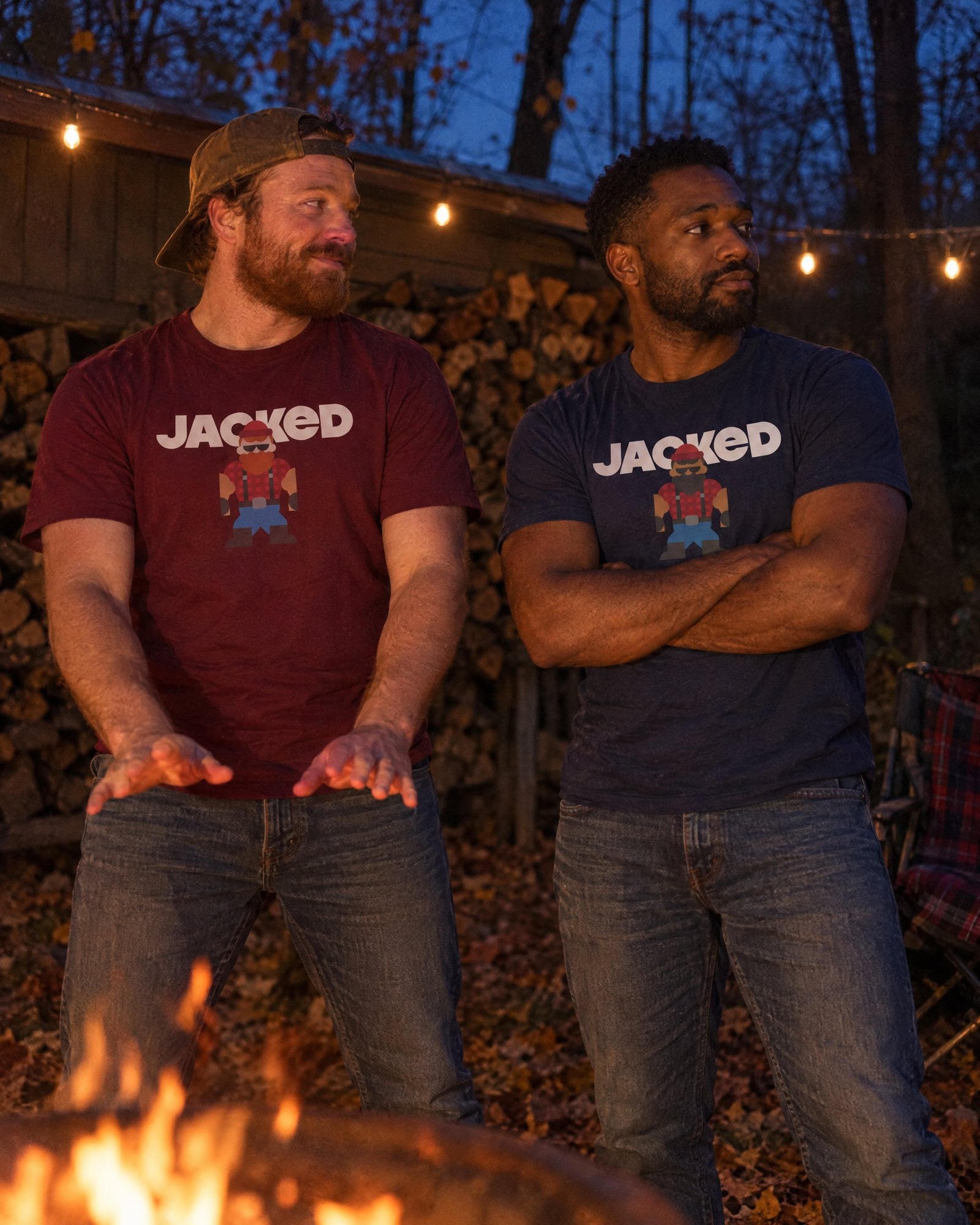 Two mates standing by a backyard fire pit at dusk in the maroon Jacked Jack tee and the navy Jacked Forest tee